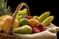 Horizontal Closeup detail on a basket full of fruit on a dark background